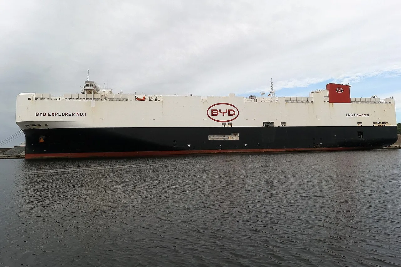 The car carrier BYD Explorer No. 1, a tall white ship with a black hull, moored in a harbor