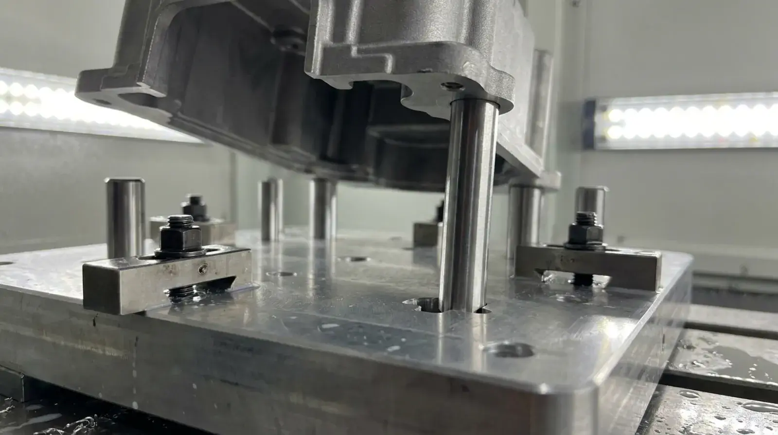 Machining fixture with one taller locating pin ensuring correct workpiece loading orientation