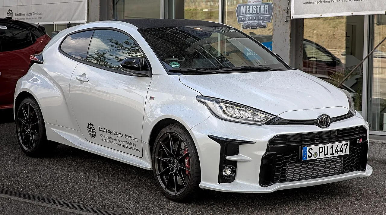 White Toyota GR Yaris parked outside a dealership